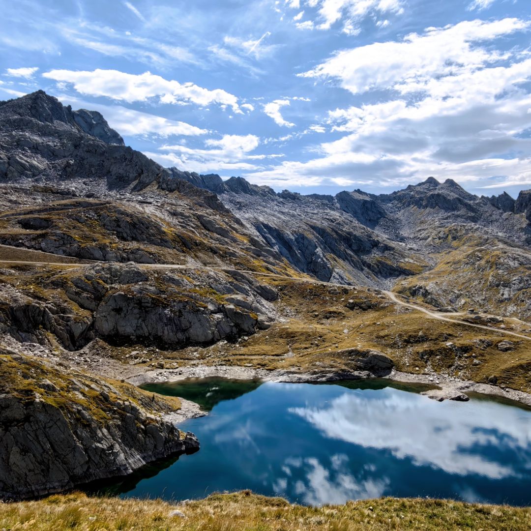Dark lake, altitude 2259 meters, and its peak with the same name (2648 müM) seen from a nameless grassy peak 2335 meters high.
